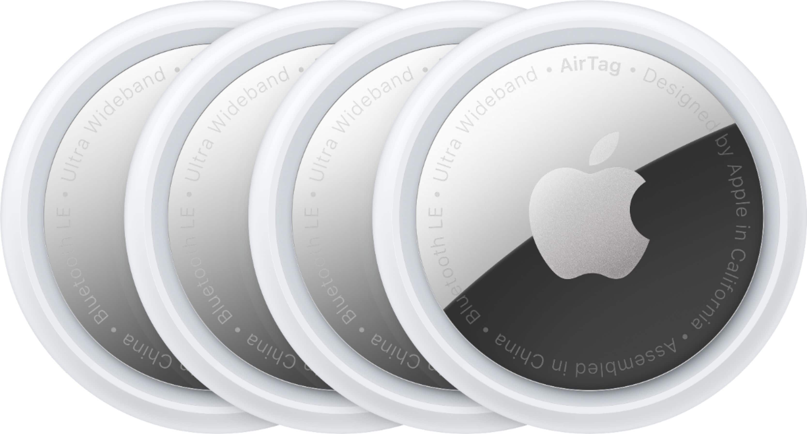 Apple AirTag 4-Pack displayed on a table with keys and a backpack